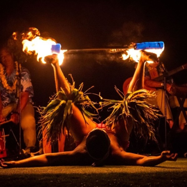 Nighttime fire dance during beachfront lūʻau at Andaz Maui