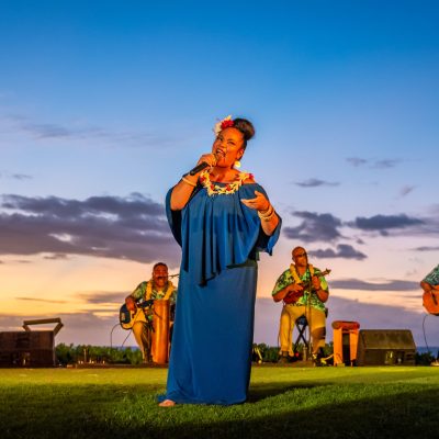 a group of people that are standing in the grass