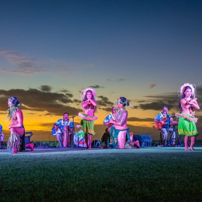 a group of people that are standing in the grass
