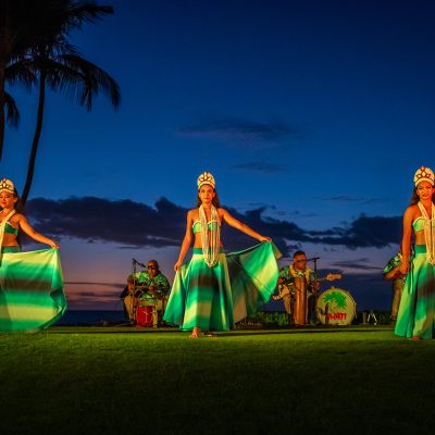 a group of people flying colorful kites