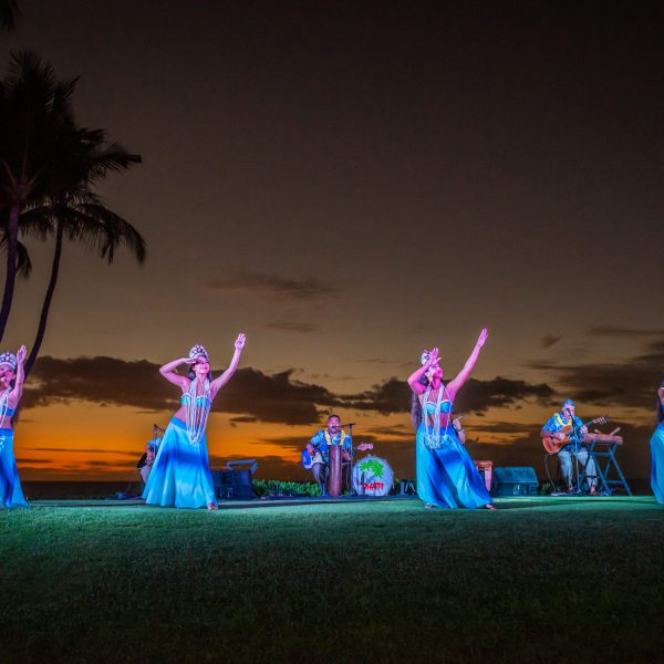 Hula dancers performing at oceanfront lūʻau in Wailea in Blue skirts