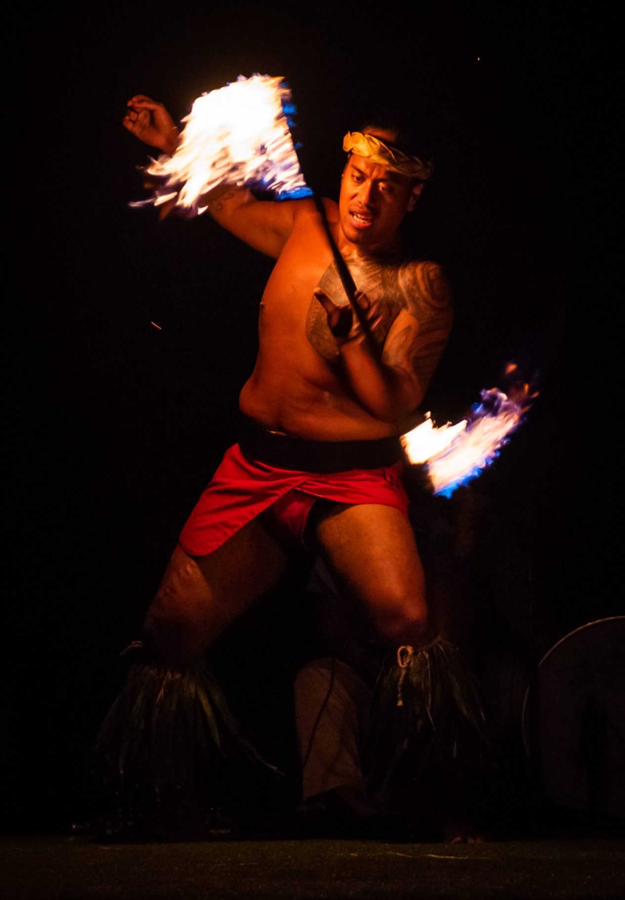 Fire dance performance at oceanfront lūʻau in Wailea